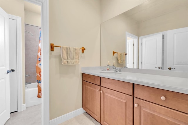 bathroom featuring tile patterned floors, baseboards, vanity, and shower / bath combination with curtain
