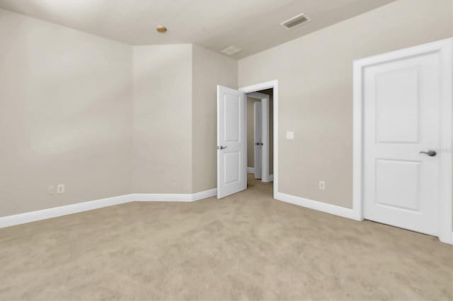 unfurnished bedroom featuring baseboards, visible vents, and light carpet