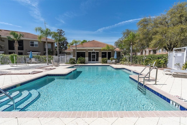 community pool featuring a patio area and fence