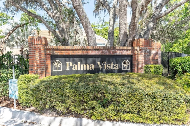 community sign featuring fence