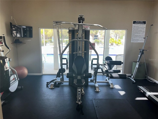 workout area with a wealth of natural light and baseboards