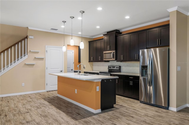 6732 Rocky Park St, Tampa, FL 33625 - kitchen featuring appliances with stainless steel finishes, a sink, an island with sink, tasteful backsplash, and crown molding