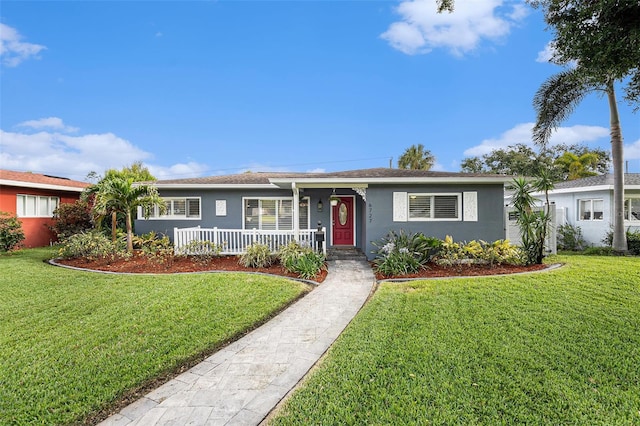 ranch-style house with a porch, stucco siding, and a front yard