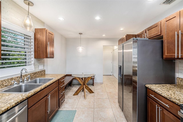 kitchen featuring recessed lighting, a sink, pendant lighting, and appliances with stainless steel finishes