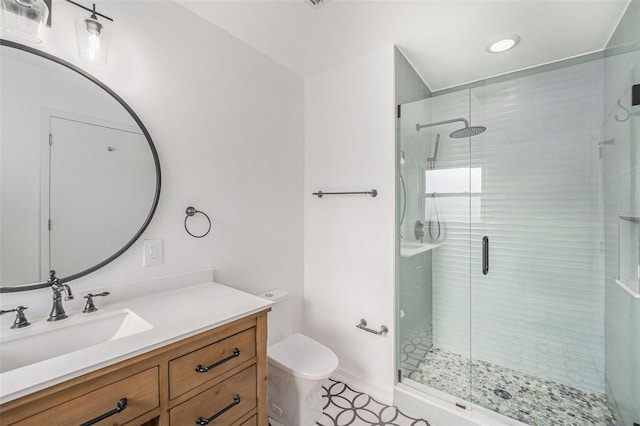bathroom with vanity, tile patterned flooring, toilet, and a shower stall