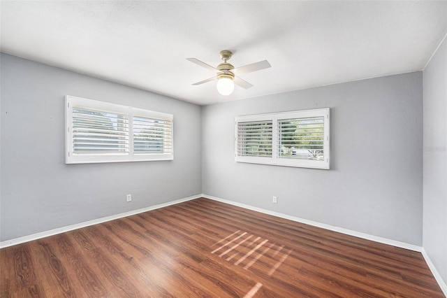 spare room featuring ceiling fan, plenty of natural light, and wood finished floors