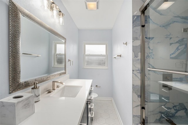 bathroom with a marble finish shower, tile patterned floors, vanity, and toilet