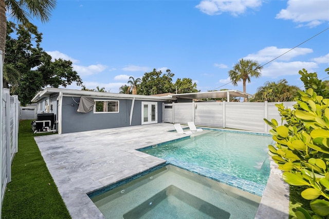 view of pool featuring an in ground hot tub, french doors, a fenced backyard, and a patio area
