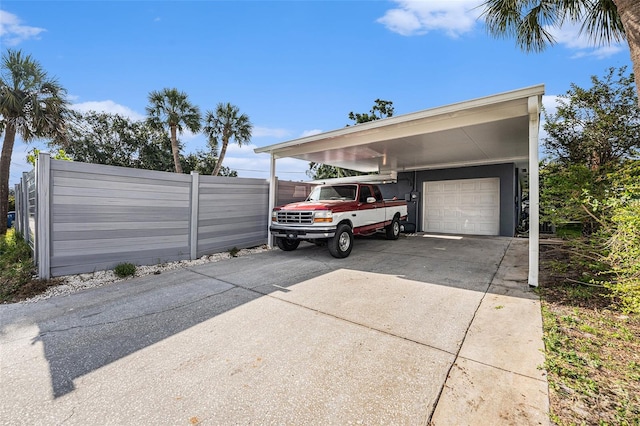 garage with fence and driveway