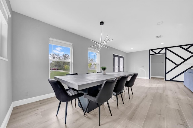 20 2nd Ave SE, Lutz, FL 33549 - dining room featuring french doors, light wood finished floors, baseboards, a chandelier, and recessed lighting