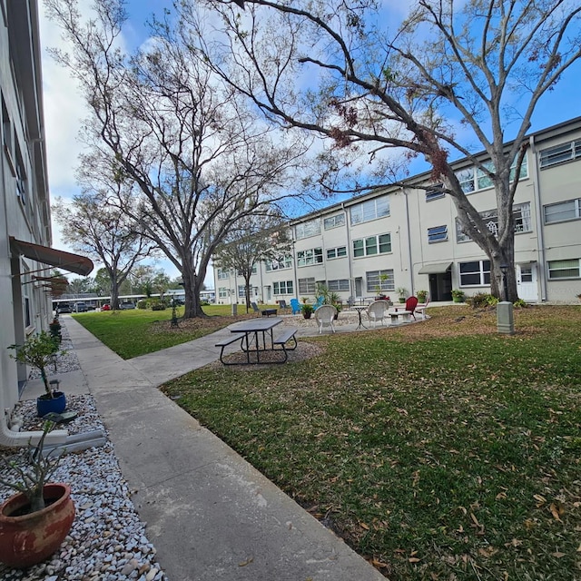 5880 38th Ave N Unit 107, Saint Petersburg, FL 33710 - view of property's community with a lawn and a residential view