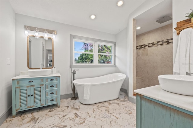 bathroom featuring visible vents, marble finish floor, a freestanding tub, recessed lighting, and vanity