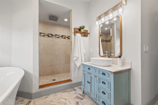 full bath featuring a freestanding tub, baseboards, a tile shower, and vanity