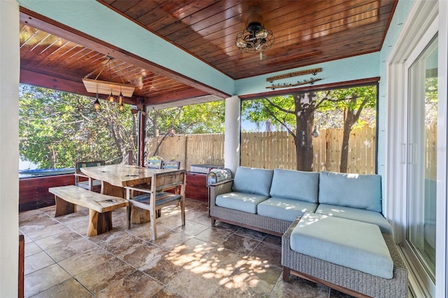 view of patio with outdoor lounge area, outdoor dining space, fence, and a hot tub