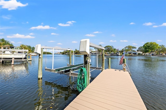 view of dock with boat lift and a water view