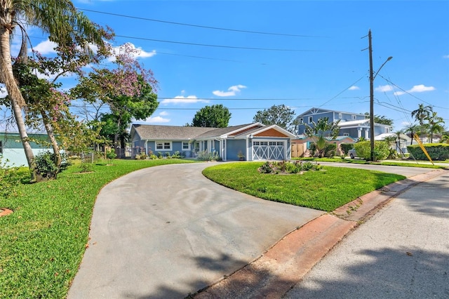 single story home with driveway, a garage, and a front yard