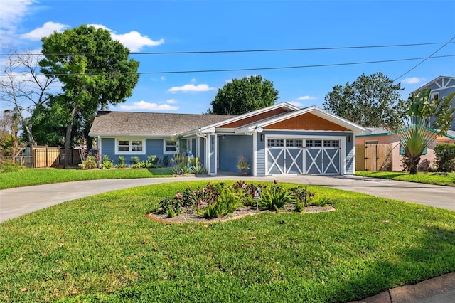 single story home featuring a garage, a front lawn, concrete driveway, and fence