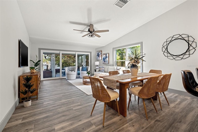 dining room with a wealth of natural light, vaulted ceiling, ceiling fan, and visible vents
