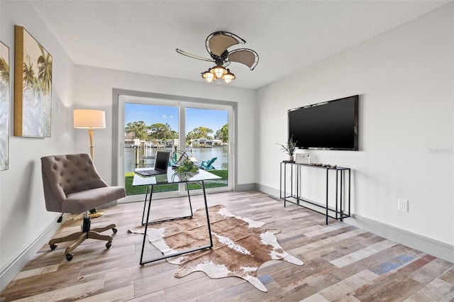 office with baseboards, ceiling fan, and wood finished floors