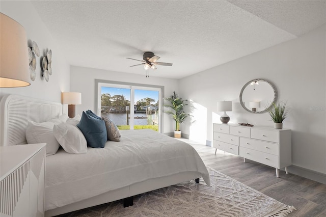 bedroom with access to outside, baseboards, a textured ceiling, light wood-style floors, and ceiling fan