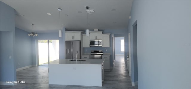 kitchen featuring a wealth of natural light, white cabinetry, stainless steel appliances, and an inviting chandelier