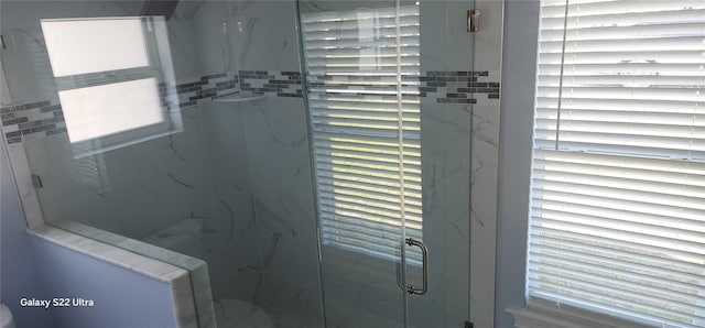 details featuring a marble finish shower
