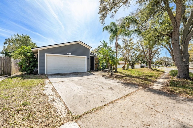 1366 Wexford Dr N, Palm Harbor, FL 34683 - garage featuring driveway and fence