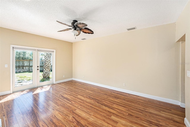 1366 Wexford Dr N, Palm Harbor, FL 34683 - spare room featuring baseboards, wood finished floors, visible vents, and ceiling fan