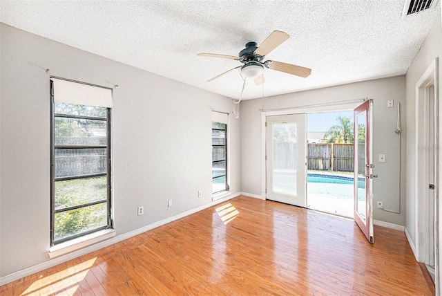 1366 Wexford Dr N, Palm Harbor, FL 34683 - unfurnished room featuring plenty of natural light, ceiling fan, and light wood-style floors