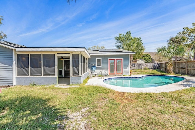 1366 Wexford Dr N, Palm Harbor, FL 34683 - rear view of property featuring a yard, french doors, a fenced backyard, and a sunroom