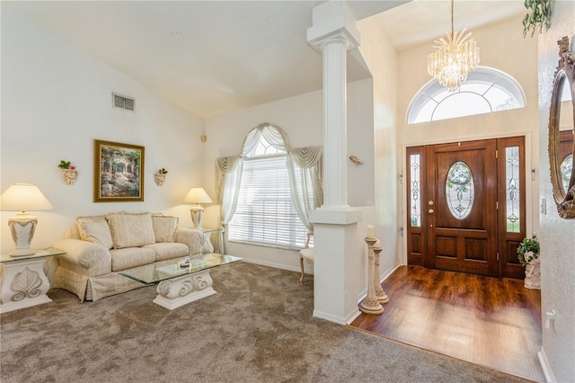 3627 Cypress Meadows Rd, Tampa, FL 33624 - carpeted entrance foyer featuring high vaulted ceiling, visible vents, a chandelier, ornate columns, and baseboards