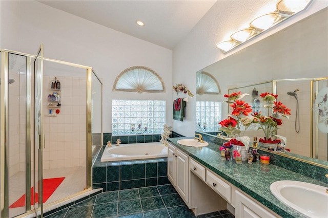 3627 Cypress Meadows Rd, Tampa, FL 33624 - bathroom featuring a shower stall, double vanity, a sink, and a garden tub