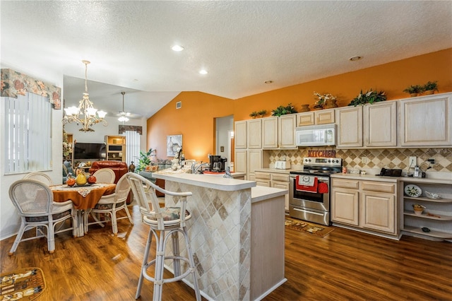 3627 Cypress Meadows Rd, Tampa, FL 33624 - kitchen with light countertops, lofted ceiling, electric stove, white microwave, and an inviting chandelier