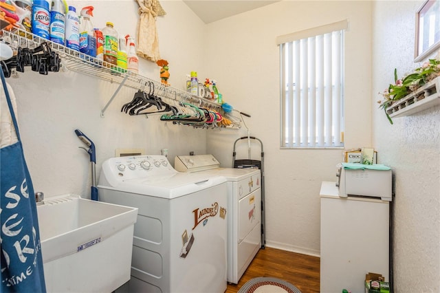 3627 Cypress Meadows Rd, Tampa, FL 33624 - washroom with a sink, washer and dryer, laundry area, and wood finished floors