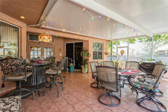 3627 Cypress Meadows Rd, Tampa, FL 33624 - sunroom / solarium with plenty of natural light, outdoor dining space, and rail lighting
