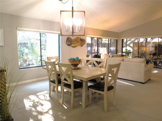 700 Starkey Rd Unit 821, Largo, FL 33771 - dining space featuring a textured ceiling, baseboards, a notable chandelier, and vaulted ceiling