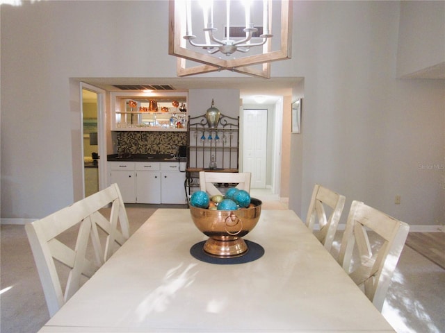 700 Starkey Rd Unit 821, Largo, FL 33771 - dining room with visible vents, baseboards, and a chandelier