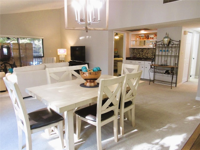 700 Starkey Rd Unit 821, Largo, FL 33771 - dining space with visible vents, light colored carpet, and a chandelier