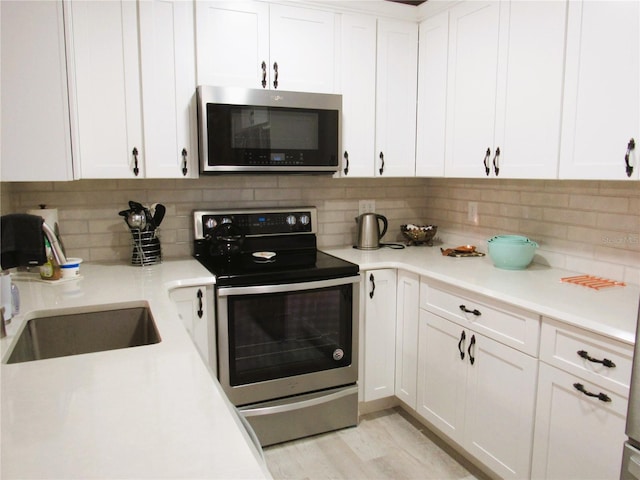 700 Starkey Rd Unit 821, Largo, FL 33771 - kitchen with tasteful backsplash, appliances with stainless steel finishes, and white cabinetry