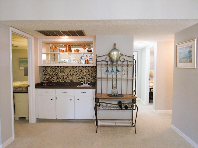700 Starkey Rd Unit 821, Largo, FL 33771 - interior space with visible vents, a sink, white cabinets, dark countertops, and tasteful backsplash