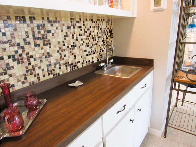 700 Starkey Rd Unit 821, Largo, FL 33771 - kitchen featuring dark countertops, white cabinets, tasteful backsplash, and a sink