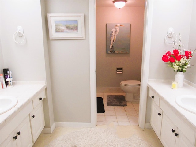 700 Starkey Rd Unit 821, Largo, FL 33771 - bathroom featuring toilet, tile patterned floors, two vanities, and a sink
