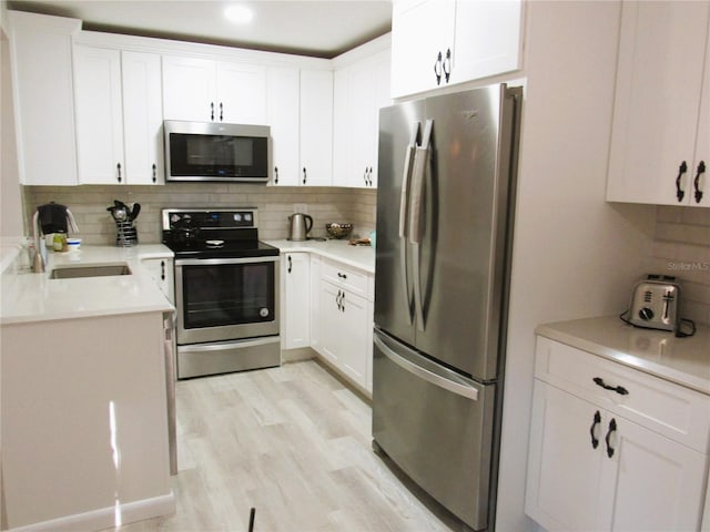 700 Starkey Rd Unit 821, Largo, FL 33771 - kitchen featuring decorative backsplash, appliances with stainless steel finishes, and white cabinetry