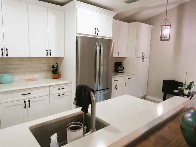 700 Starkey Rd Unit 821, Largo, FL 33771 - kitchen featuring white cabinets, hanging light fixtures, and freestanding refrigerator