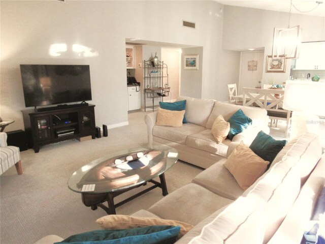 700 Starkey Rd Unit 821, Largo, FL 33771 - carpeted living room with visible vents and high vaulted ceiling