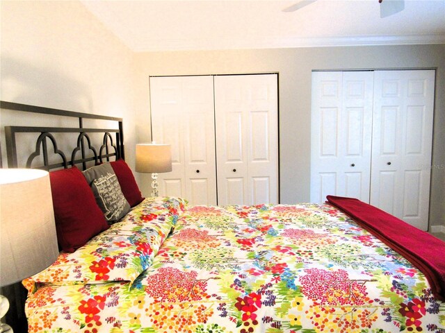 700 Starkey Rd Unit 821, Largo, FL 33771 - bedroom featuring a ceiling fan, two closets, and crown molding