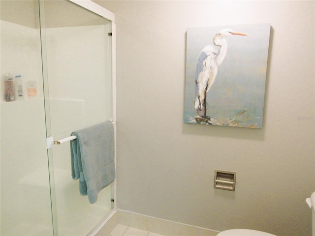 700 Starkey Rd Unit 821, Largo, FL 33771 - bathroom featuring baseboards, toilet, a shower stall, and tile patterned flooring