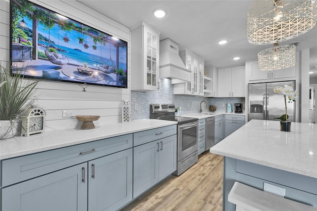 812 Gulf # 3, Indian Rocks Beach, FL 33785 - kitchen featuring light stone countertops, a sink, custom exhaust hood, and appliances with stainless steel finishes