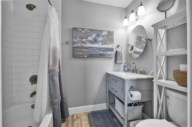 812 Gulf # 3, Indian Rocks Beach, FL 33785 - full bath with baseboards, wood finished floors, toilet, vanity, and shower / bath combination with curtain