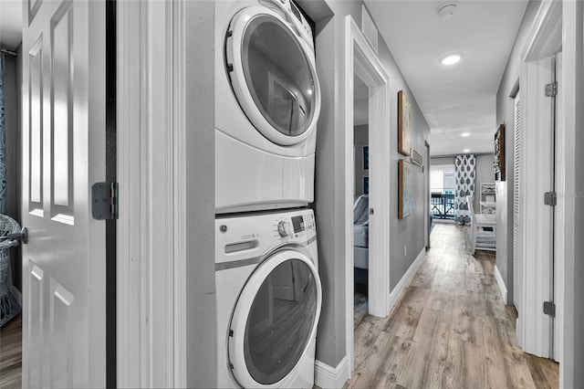 812 Gulf # 3, Indian Rocks Beach, FL 33785 - washroom with recessed lighting, light wood-type flooring, baseboards, stacked washing maching and dryer, and laundry area